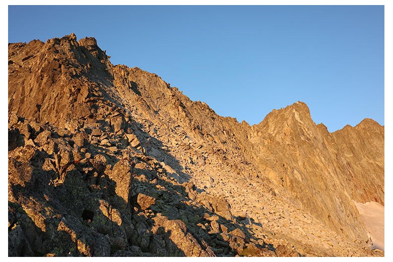 shades of two mountain climbers at sunrise with the view of the salenques-tempestades ridge